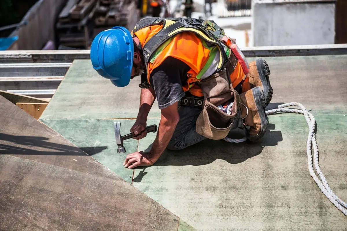 Roofer installing shingles on a Dallas roof